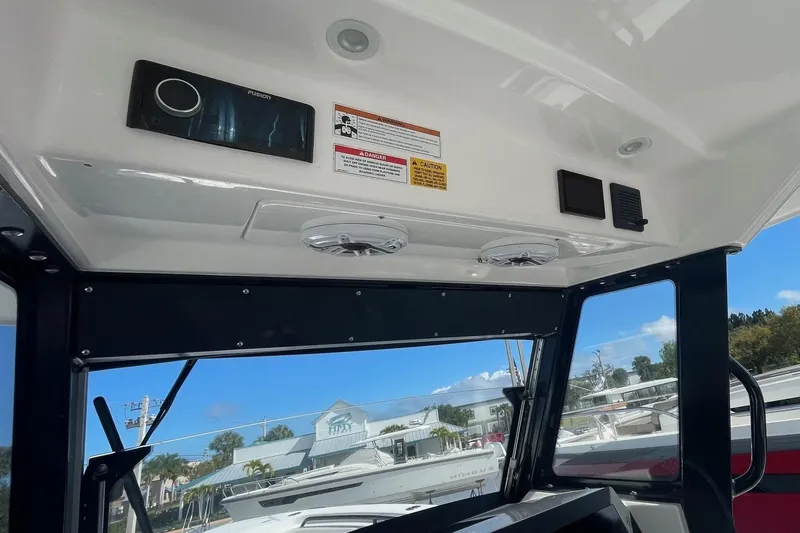 Slide: The Image of Interior view of 2022 Everglades 335 Center Console boat with audio system and controls. - 24