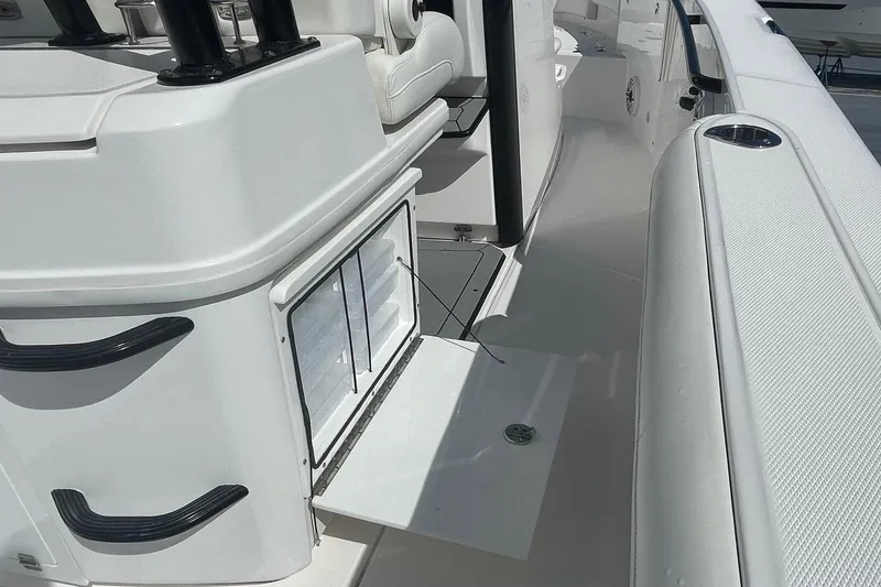 Slide: The Image of 2022 Everglades 335 Center Console boat interior with open storage compartment. - 25