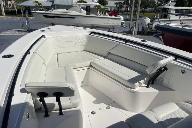 Slide: The Image of 2022 Everglades 335 Center Console boat with spacious white seating area. - 30