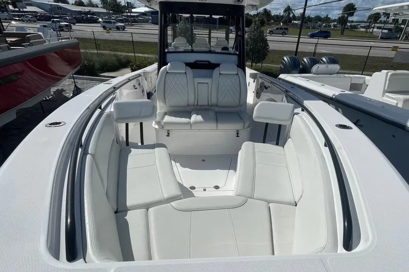 Slide: The Image of 2022 Everglades 335 Center Console boat with spacious white seating area. - 35