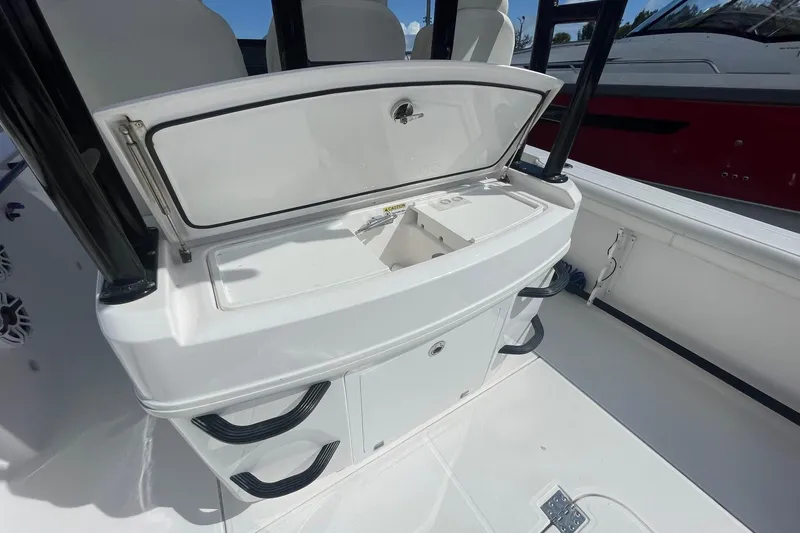 Slide: The Image of 2022 Everglades 335 Center Console boat interior with open storage compartment. - 8