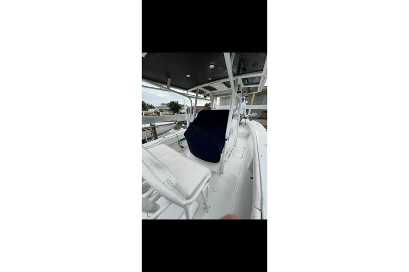 Slide: The Image of 2003 Jupiter 31 boat interior with white seating and blue cover. - 10