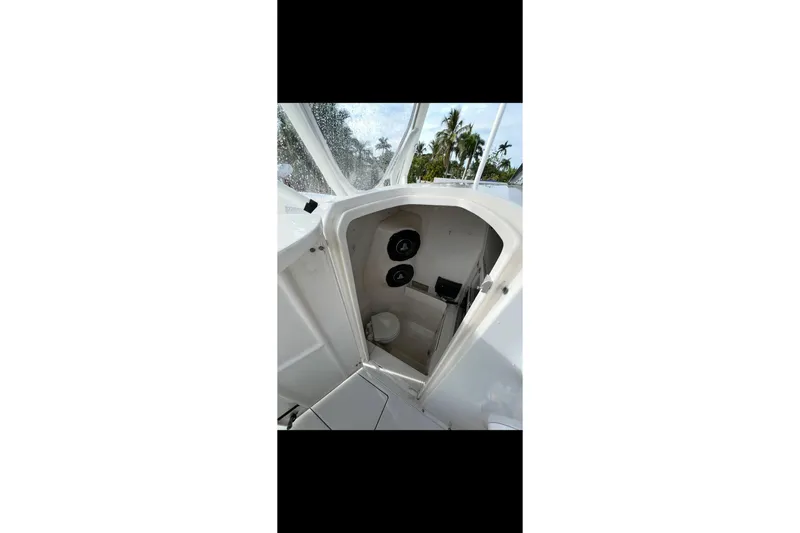 Slide: The Image of 2003 Jupiter 31 boat interior cabin with white finish and visible controls. - 17
