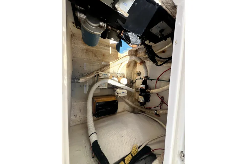 Slide: The Image of 2003 Jupiter 31 boat engine compartment with hoses and mechanical components. - 20
