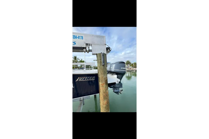 Slide: The Image of 2003 Jupiter 31 boat docked with Yamaha outboard motor in a marina setting. - 4