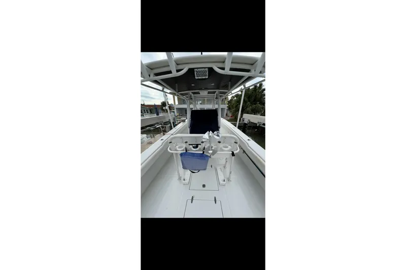 Slide: The Image of 2003 Jupiter 31 boat interior with fishing rod holders and seating. - 9