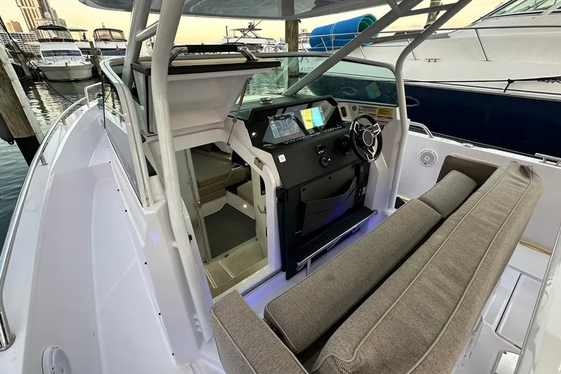 Slide: The Image of 2024 Axopar 37 Sun-Top boat interior with helm, seating, and modern controls. - 15