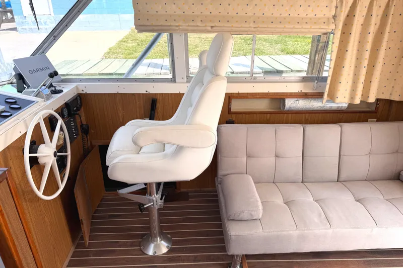 Slide: The Image of Interior of a 1974 Bertram 35 Convertible boat with helm and seating area. - 10
