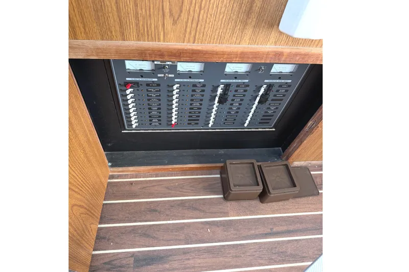 Slide: The Image of Electrical panel on a 1974 Bertram 35 Convertible boat with wooden flooring. - 12