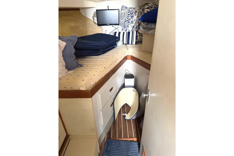 Slide: The Image of Interior cabin of a 1974 Bertram 35 Convertible boat with bedding and decor. - 14