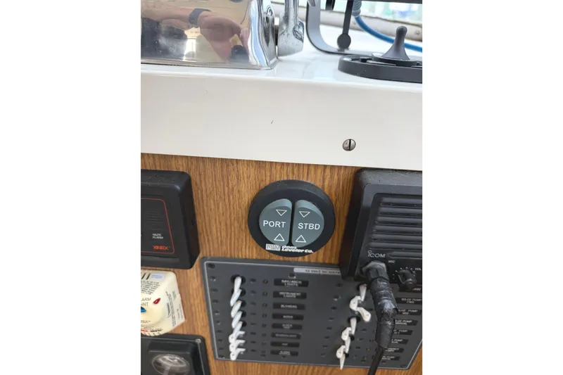 Slide: The Image of Control panel of a 1974 Bertram 35 Convertible boat with port and starboard buttons. - 18
