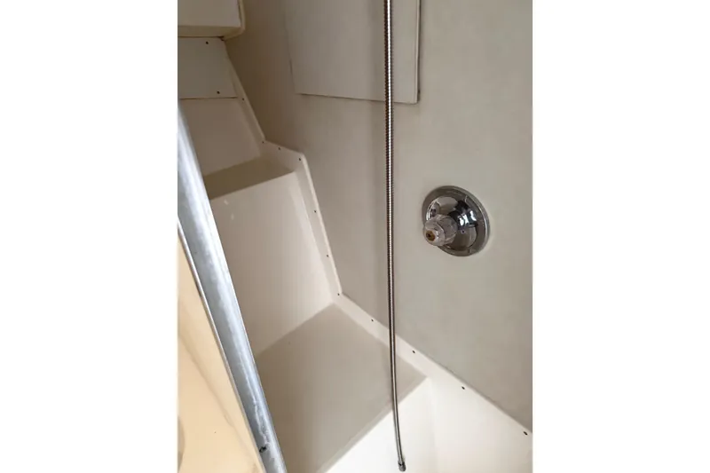 Slide: The Image of Interior of 1974 Bertram 35 Convertible boat, featuring a shower area with chrome fixtures. - 22