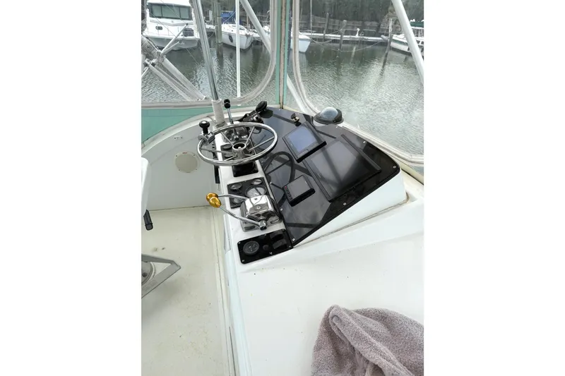 Slide: The Image of 1974 Bertram 35 Convertible helm with steering wheel and navigation equipment. - 26