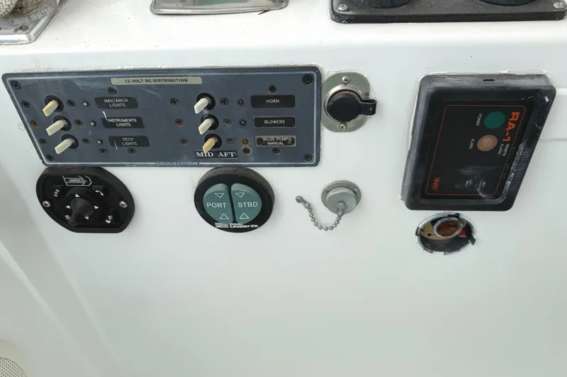 Slide: The Image of Control panel of a 1974 Bertram 35 Convertible boat with various switches and indicators. - 28