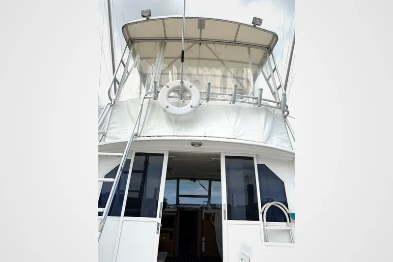 Slide: The Image of 1974 Bertram 35 Convertible boat with upper deck and life preserver. - 30