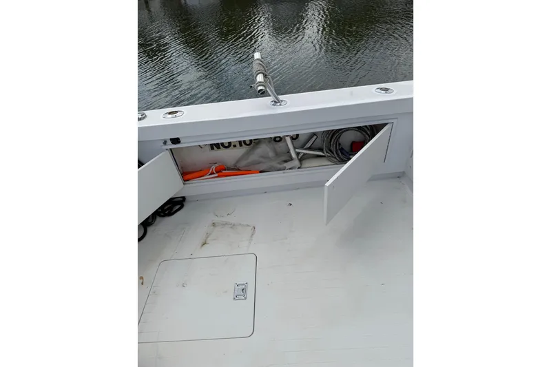 Slide: The Image of 1974 Bertram 35 Convertible boat deck with open storage compartment. - 32