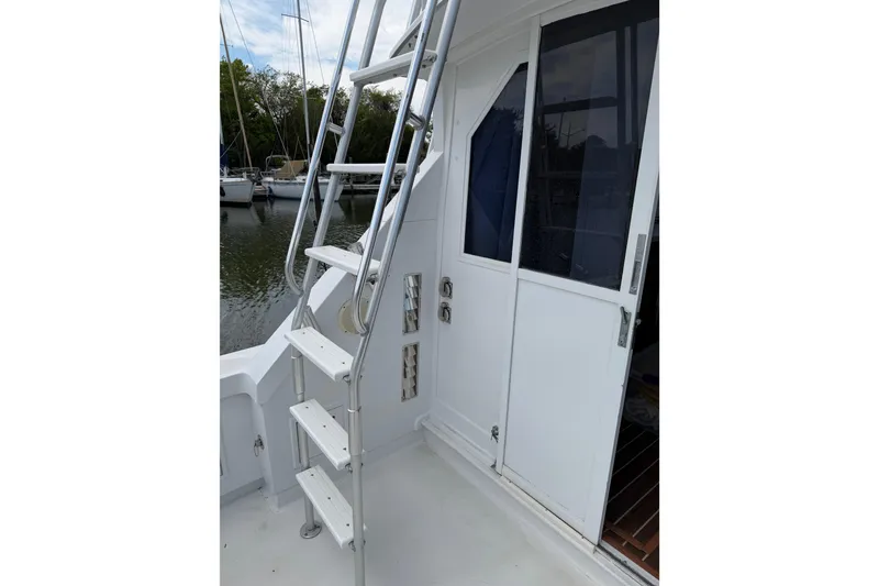 Slide: The Image of 1974 Bertram 35 Convertible boat with metal ladder and white cabin door. - 34