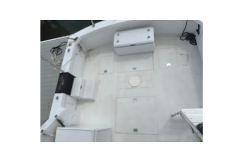 Slide: The Image of 1974 Bertram 35 Convertible boat deck with storage compartments and seating. - 36