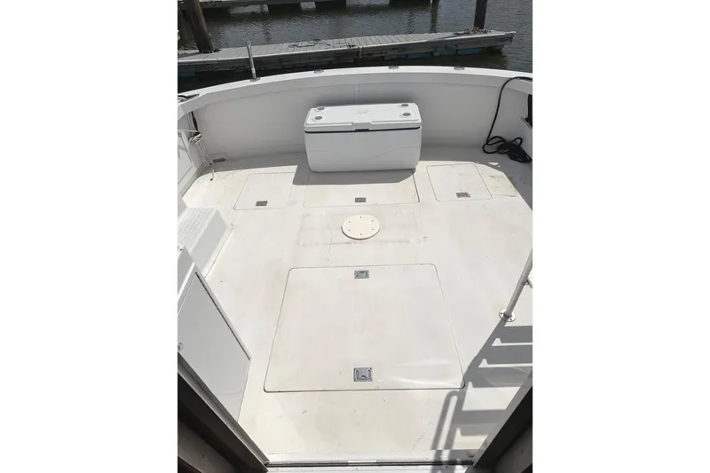 Slide: The Image of 1974 Bertram 35 Convertible boat deck with storage compartments and seating. - 37