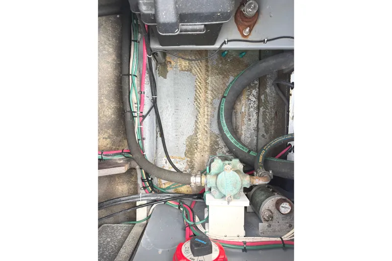 Slide: The Image of Engine compartment of a 1974 Bertram 35 Convertible with hoses and wiring. - 38
