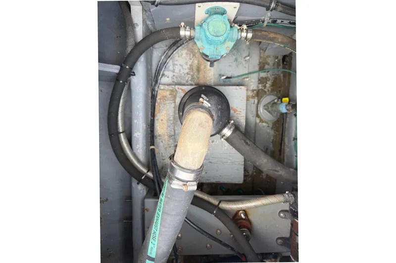 Slide: The Image of Engine compartment of a 1974 Bertram 35 Convertible with hoses and fittings. - 39