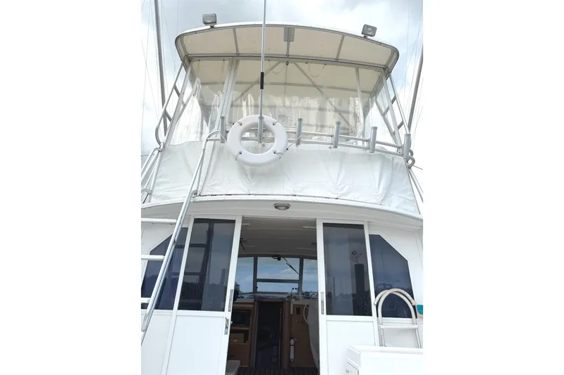 Slide: The Image of 1974 Bertram 35 Convertible boat with upper deck and life preserver. - 4
