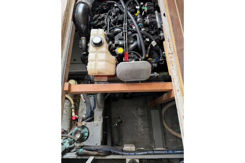 Slide: The Image of Engine compartment of a 1974 Bertram 35 Convertible boat, showcasing mechanical components. - 41