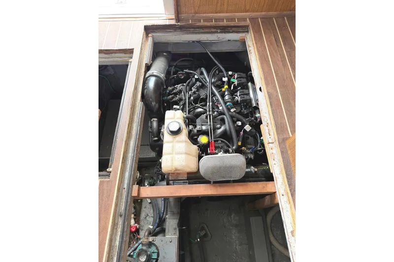 Slide: The Image of Engine compartment of a 1974 Bertram 35 Convertible boat, showcasing detailed components. - 42