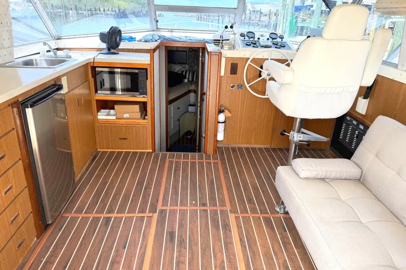Slide: The Image of Interior of a 1974 Bertram 35 Convertible yacht with wood flooring and modern amenities. - 5