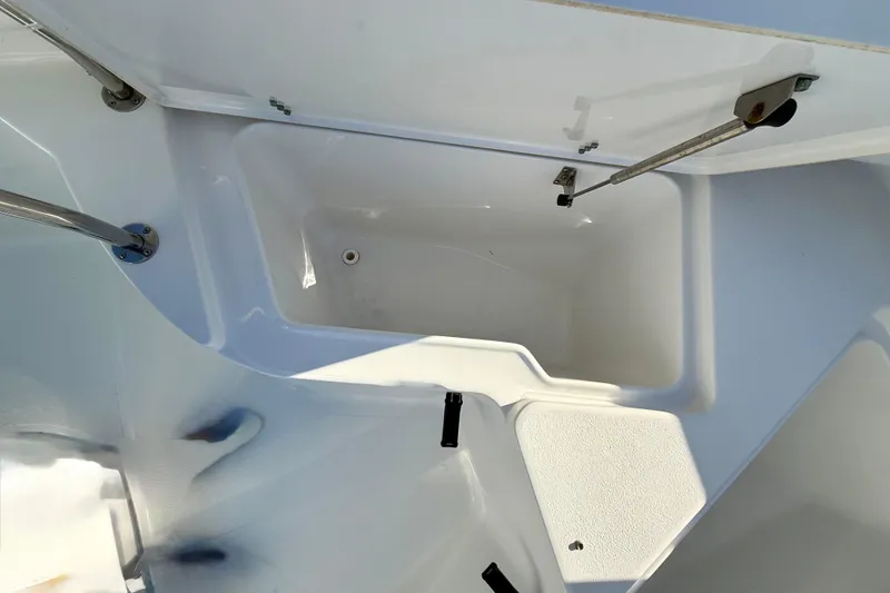 Slide: The Image of Open storage compartment on a 2017 Sea Hunt Triton 225 boat. - 12