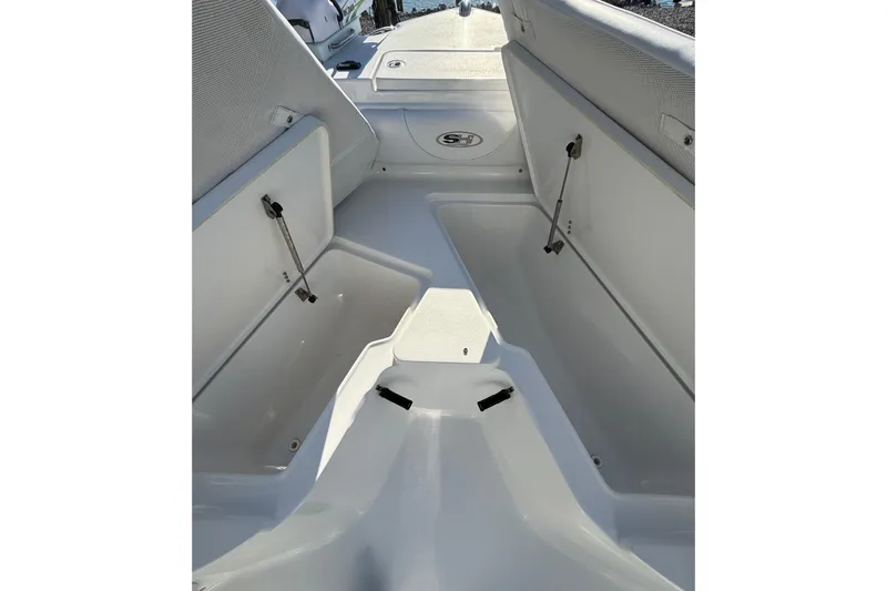 Slide: The Image of 2017 Sea Hunt Triton 225 boat interior with open storage compartments. - 13