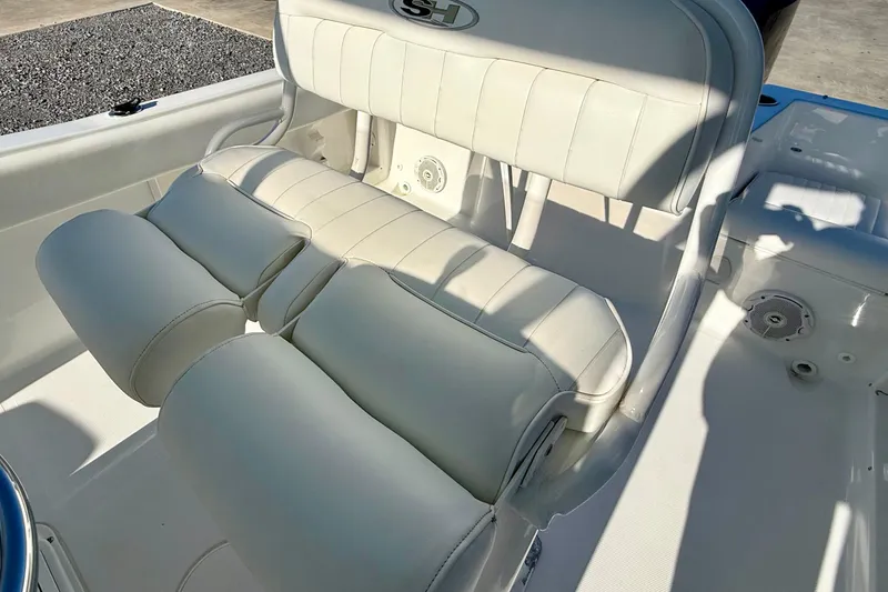 Slide: The Image of 2017 Sea Hunt Triton 225 boat with white cushioned seating and sleek design. - 14