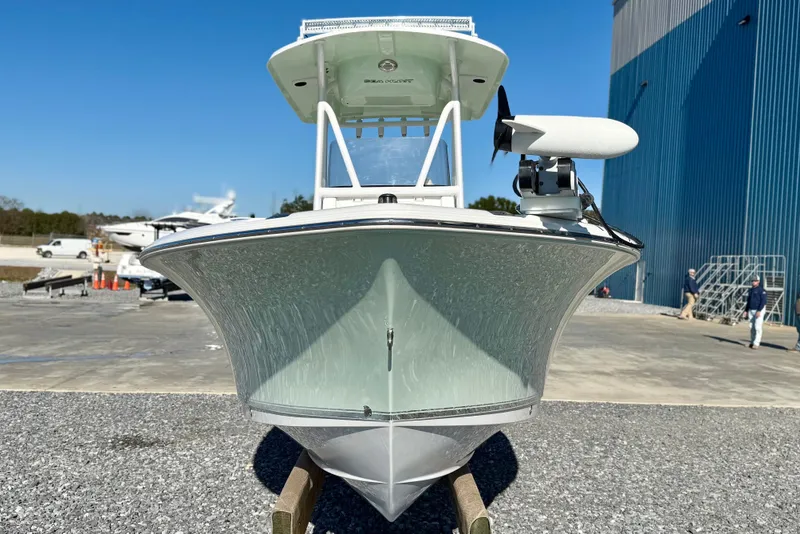 Slide: The Image of 2017 Sea Hunt Triton 225 boat on display outdoors near a blue building. - 2