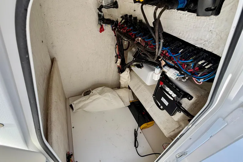 Slide: The Image of Electrical compartment of 2017 Sea Hunt Triton 225 boat, featuring wiring and components. - 21
