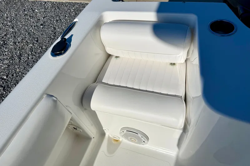 Slide: The Image of 2017 Sea Hunt Triton 225 boat seat with white upholstery and cup holder. - 22