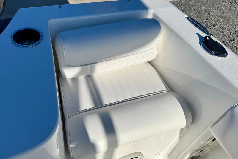 Slide: The Image of White cushioned seat on 2017 Sea Hunt Triton 225 boat, featuring cup holder and sleek design. - 23