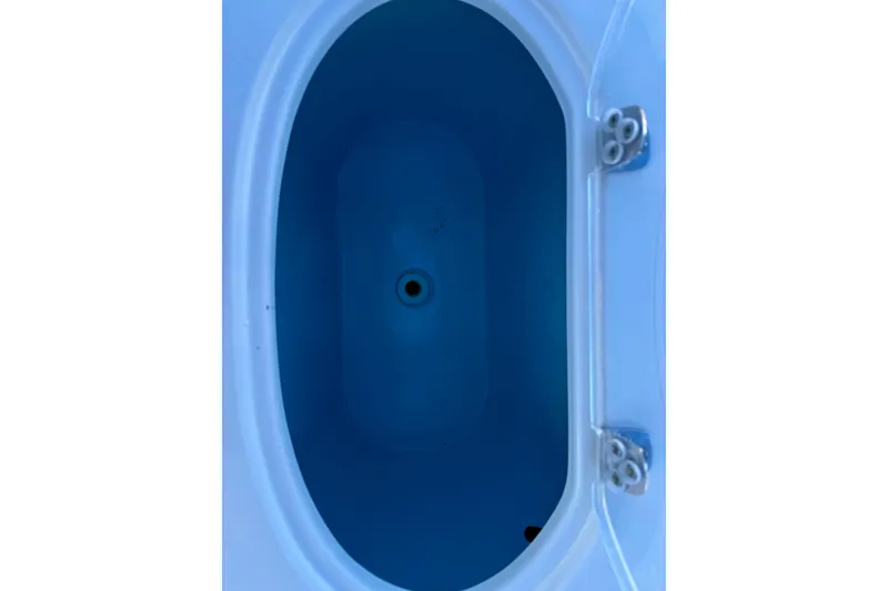 Slide: The Image of 2017 Sea Hunt Triton 225 livewell interior, oval shape, blue color. - 24