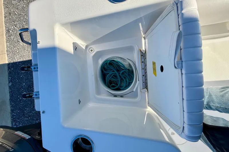 Slide: The Image of 2017 Sea Hunt Triton 225 boat storage compartment with rope inside. - 25