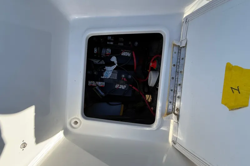 Slide: The Image of Battery compartment of a 2017 Sea Hunt Triton 225 boat, showing wiring and connections. - 26