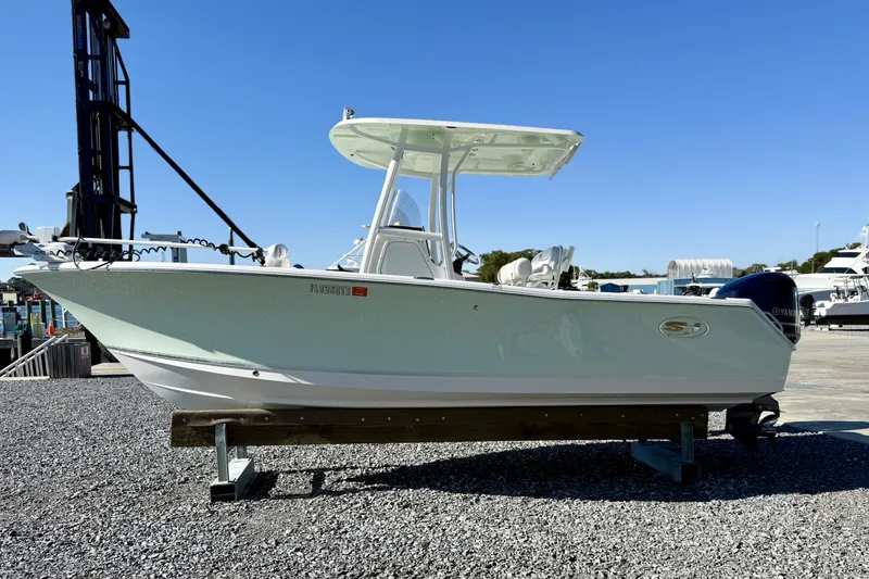 Slide: The Image of 2017 Sea Hunt Triton 225 boat on display at a marina. - 4