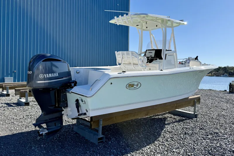 Slide: The Image of 2017 Sea Hunt Triton 225 boat with Yamaha engine, displayed outdoors near water. - 7