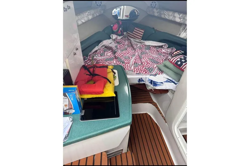 Slide: The Image of Interior of 2000 Four Winns 268 Vista boat with American-themed bedding and life jackets. - 10