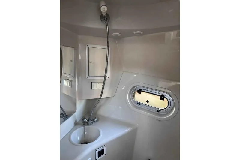 Slide: The Image of Compact bathroom in 2000 Four Winns 268 Vista boat with sink and porthole. - 15