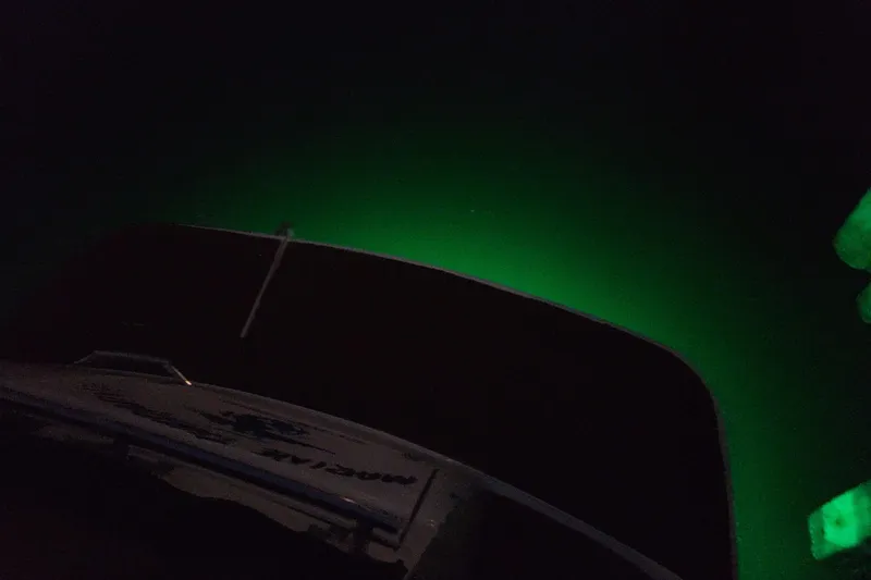 Slide: The Image of 2000 Four Winns 268 Vista boat with green underwater lighting at night. - 5