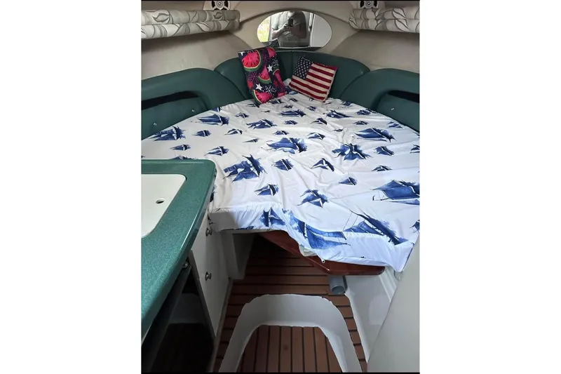 Slide: The Image of Interior of 2000 Four Winns 268 Vista boat with bed, pillows, and nautical decor. - 9
