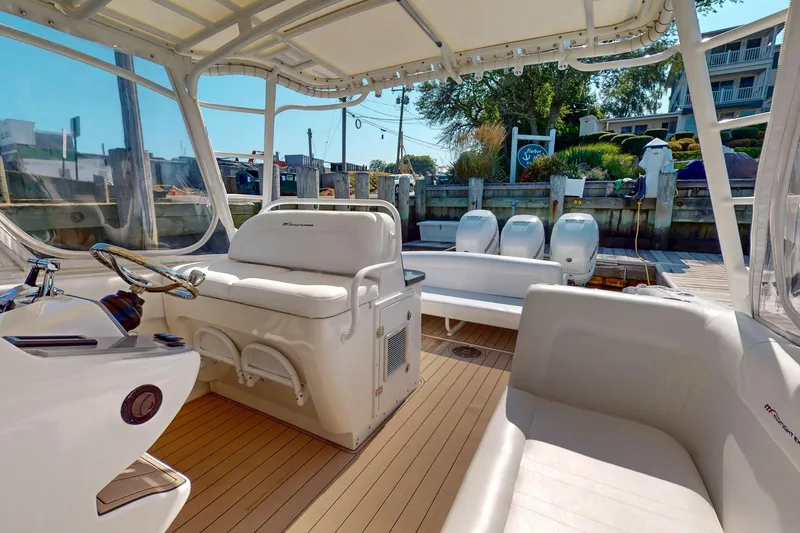 Slide: The Image of 2007 Midnight Express 37 Cabin boat interior with seating and helm, docked at marina. - 17
