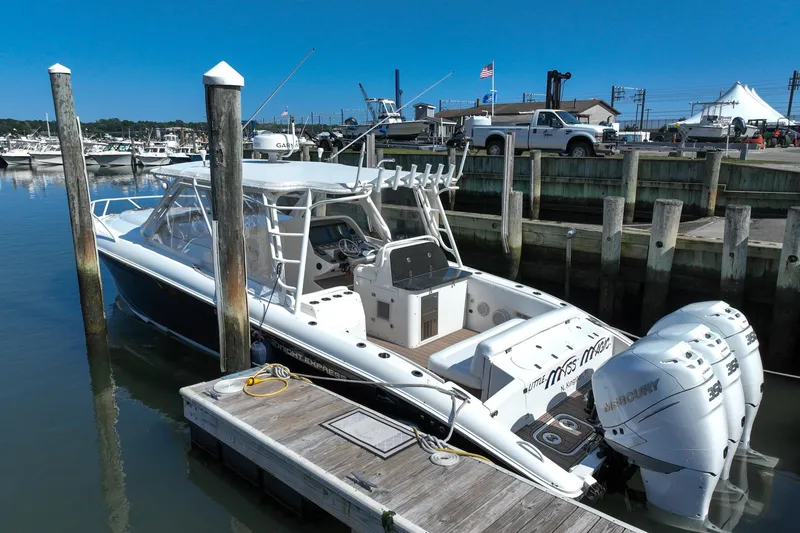 Slide: The Image of 2007 Midnight Express 37 Cabin boat docked with triple Mercury engines. - 5