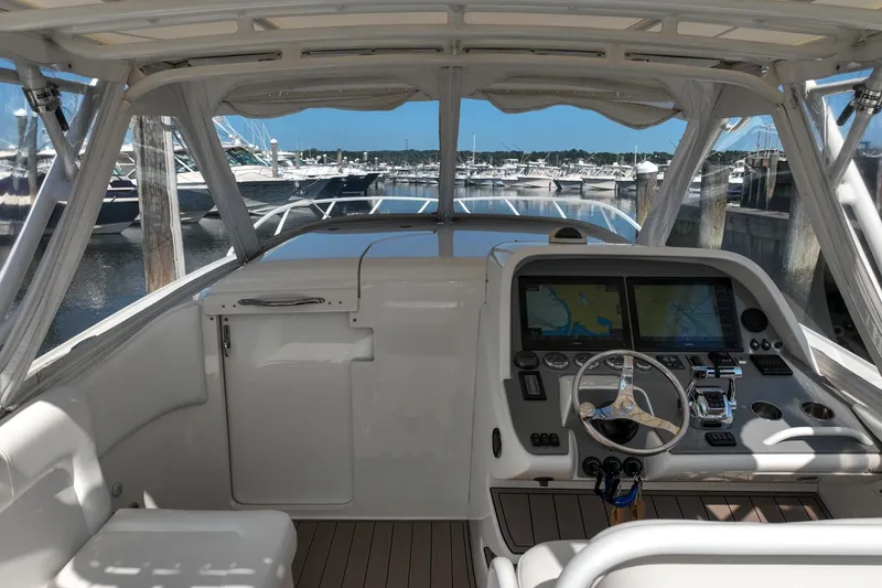 Slide: The Image of 2007 Midnight Express 37 Cabin boat interior with modern navigation system at marina. - 6
