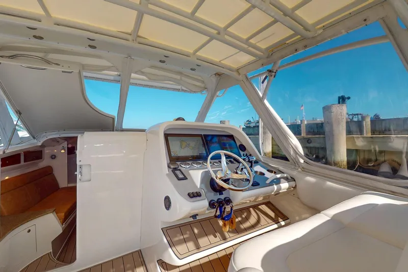 Slide: The Image of 2007 Midnight Express 37 Cabin interior with helm, navigation system, and seating. - 8
