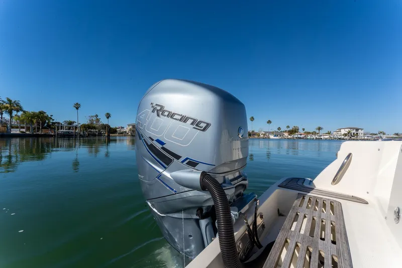 Slide: The Image of 2018 Chris-Craft Calypso 26 with powerful outboard motor on calm water. - 14